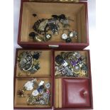 A leather jewellery box containing various oddments.