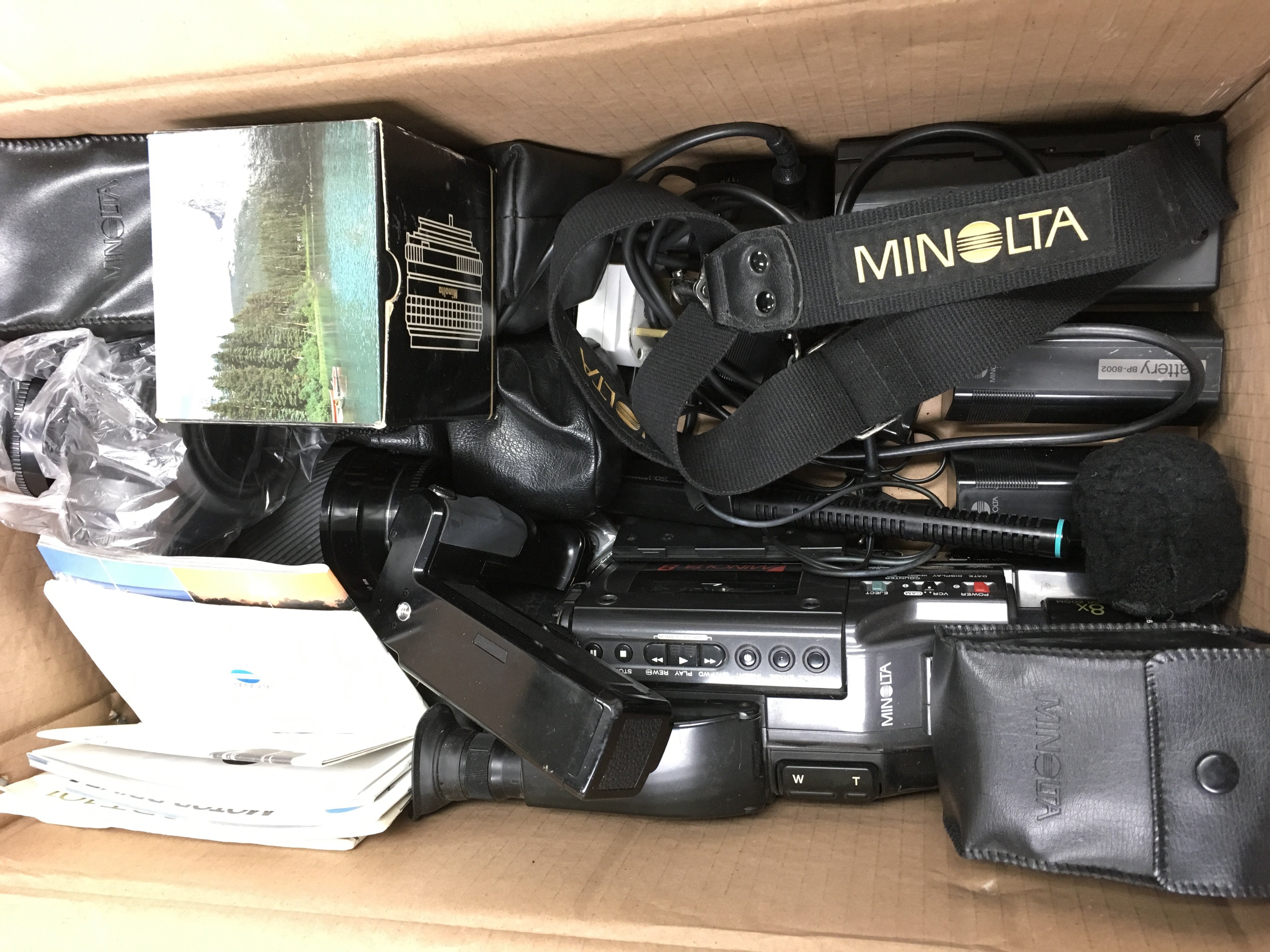 A box containing a collection of camera equipment to include cameras and lenses, mostly by Minolta. - Image 2 of 2