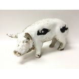 A Victorian pottery pig with flaking original pain