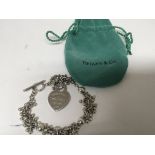 A Tiffany &co silver braclet with a heart shaped p