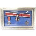 A framed collection of three third reich Iron Cross medals, all dated to the first year of World War