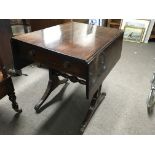 A Georgian mahogany sofa table the twin flap top a