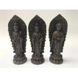 Three bronze Buddha statues.