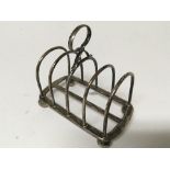 A silver toast rack with London hallmarks. Weight