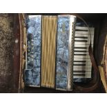A cased Mastertone accordion.