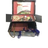 A lacquer type jewellery box and contents
