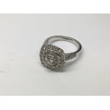 A platinum ring set with a stepped pattern of diamonds with more diamonds to the shank, approx 9.