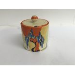 A Clarice cliff preserve jar and cover decorated in the wind bells pattern 8 cm slight paint loss no