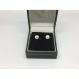 A pair of 9ct gold and pearl stud earrings.