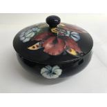 A moorcroft bowl and cover decorated with orchids