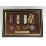 A framed and glazed set of WW2 war medals.