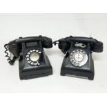 Two old rotary dial bakelite telephones.