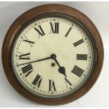 An oak station wall clock with Roman Numeral dial