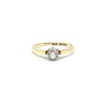 An 18ct gold ring set with a solitaire diamond. To