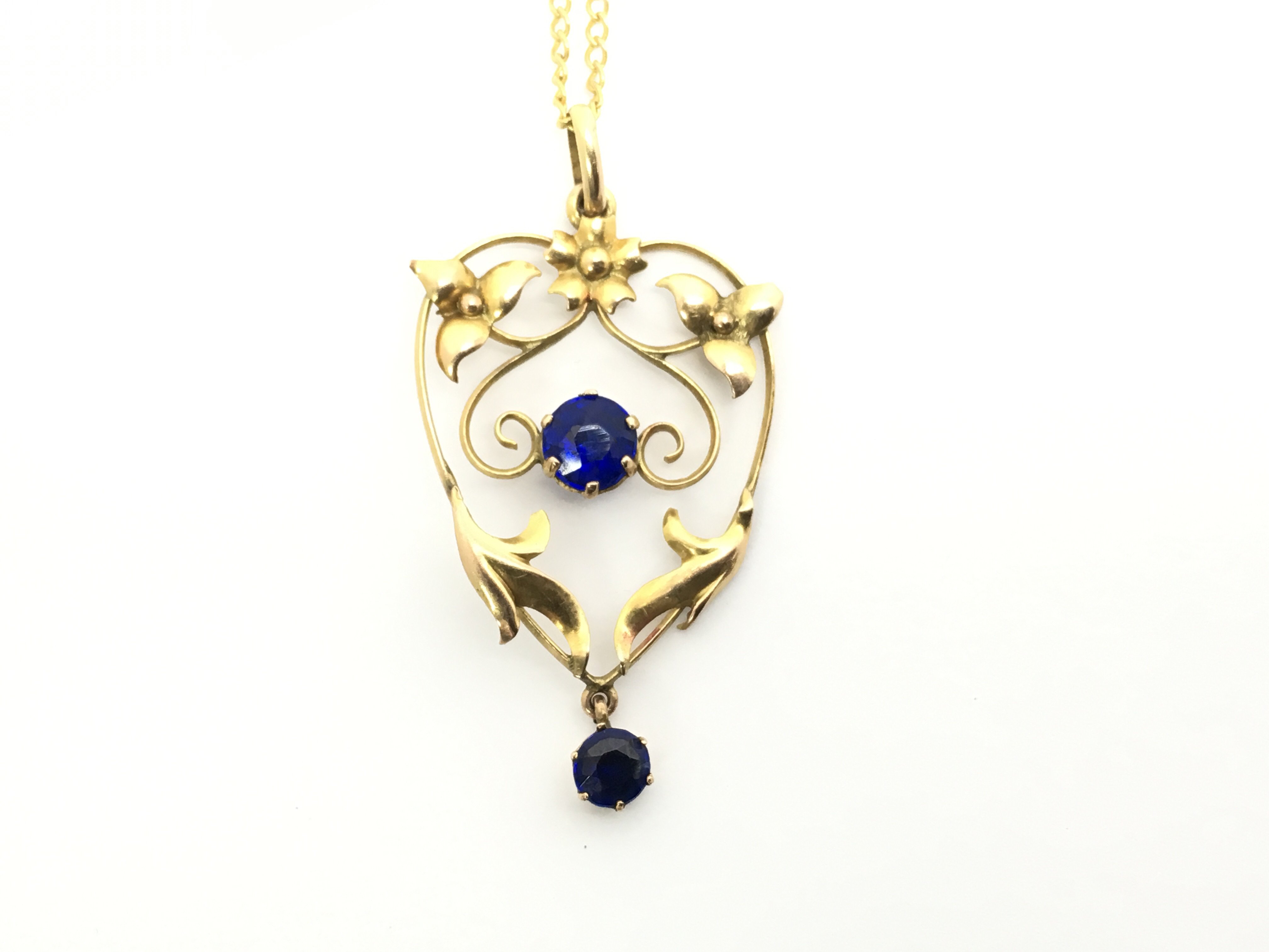 An Edwardian gold and sapphire pendant of naturali