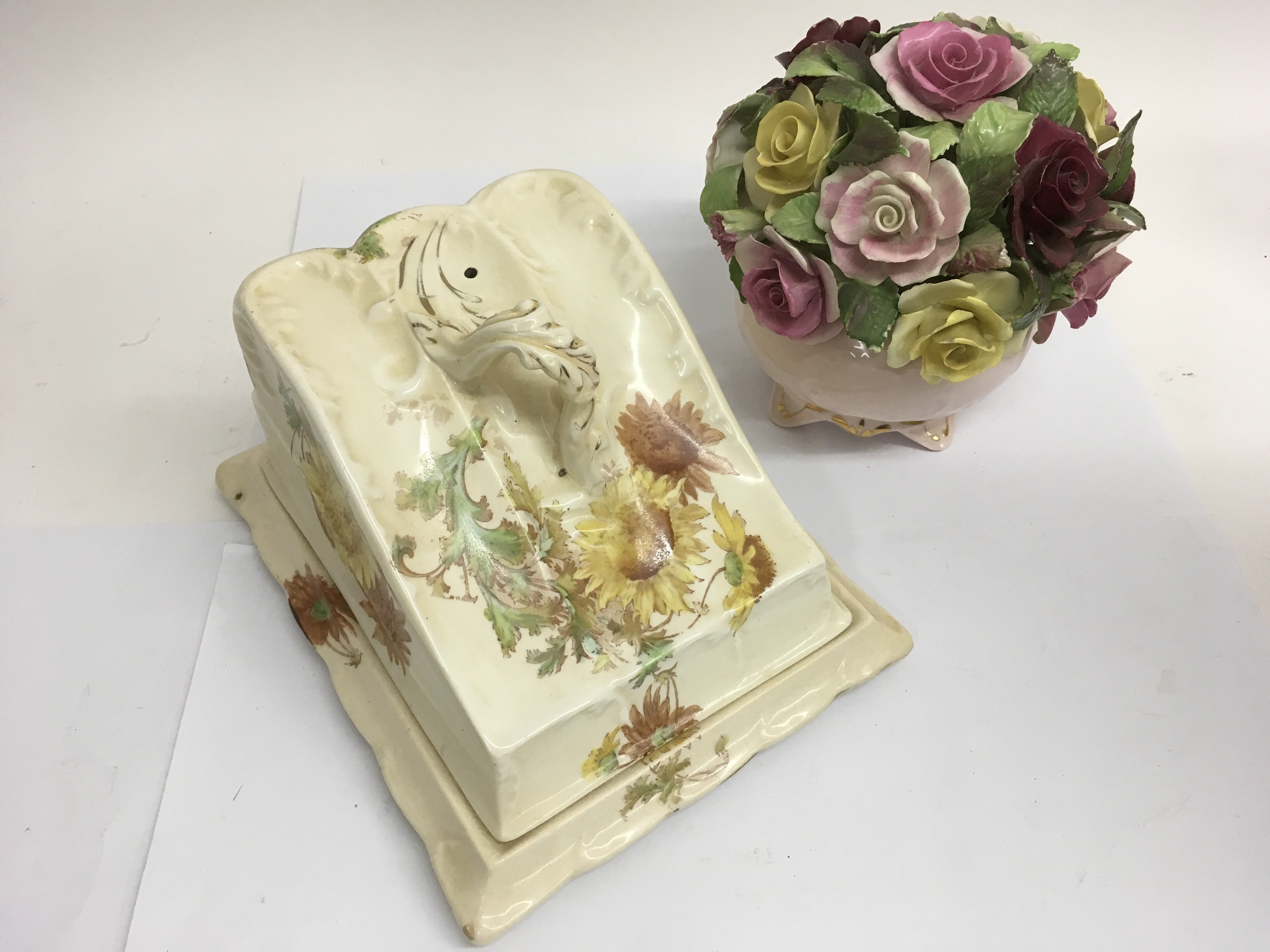 A decorative cheese dish and a flower posy