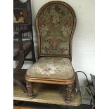 A Victorian walnut chair with floral needlepoint u