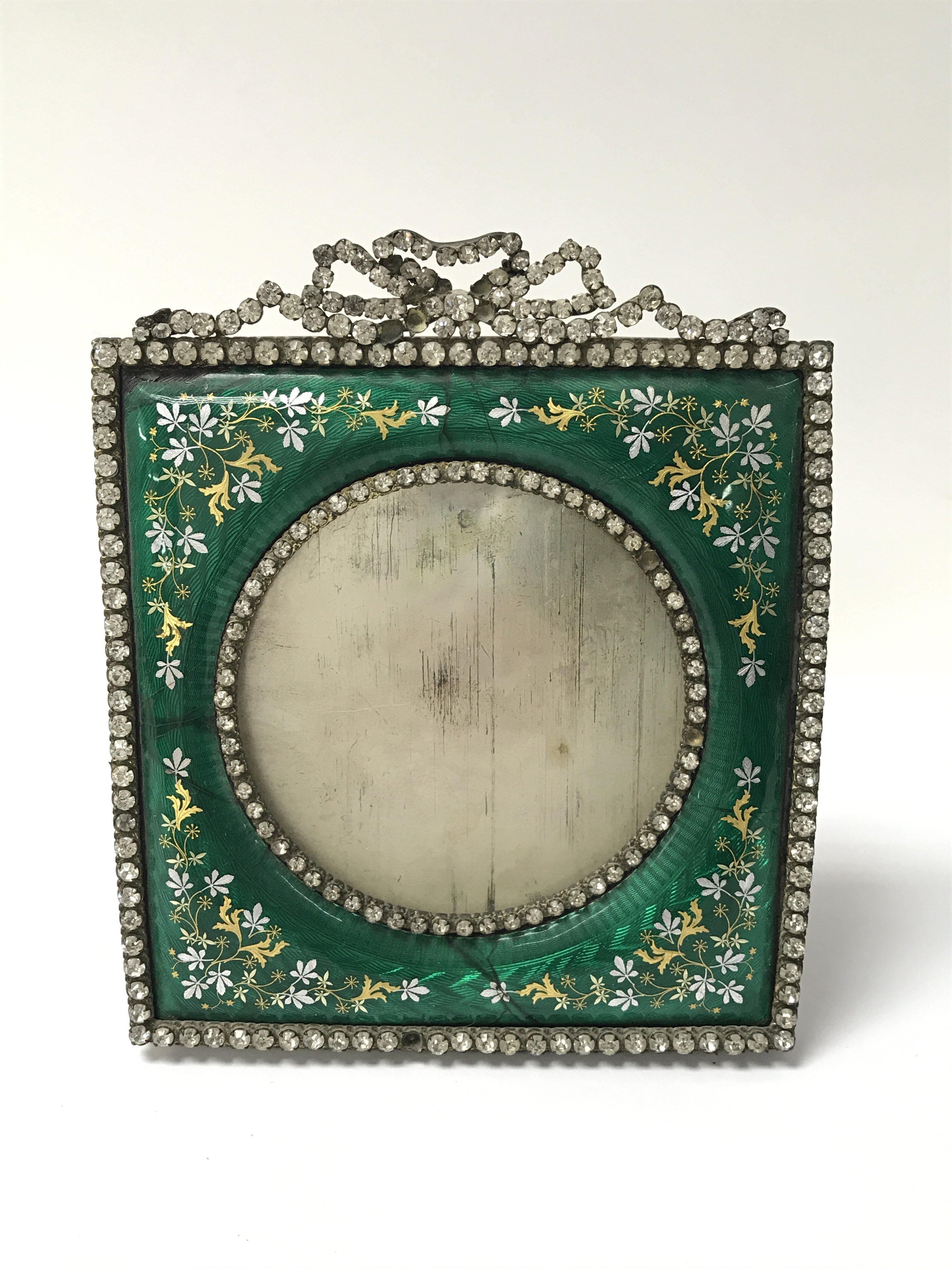 A green enamel photo frame decorate with folate de