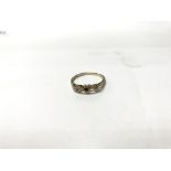 A 9ct gold ring with 3 heart shapes; the centre be