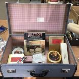 A small vintage suitcase and contents