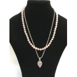 A rose quartz bead necklace and a silver chain wit