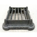 A cast iron foot scraper, measures approx 30cm x 30cm.