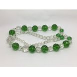 A green and clear crystal glass bead necklace.
