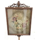 A Victorian pole screen with glazed tapestry panel
