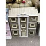 A dolls house with double hinged front. Measures a