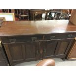 A mahogany side board with two drawers above two large cupboards. Measures approximately 138cm x