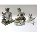Three Lladro figures including a cherub playing a