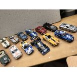 A collection of 1:18 scale diecast model vehicles,