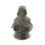 An inkwell in the form of a monk reading.