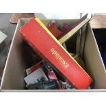 A box of model boats, toys and games equipment.