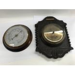A pair of wall barometers and two mirrors, one bei