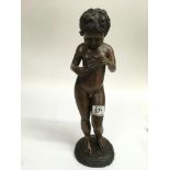 A further bronzed figure of a nude boy holding a f
