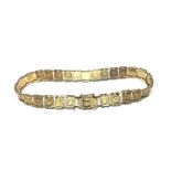 A 9ct gold bracelet, the links decorated with flow