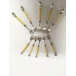 A set of white metal and bone handle pickle forks