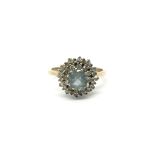 A 9ct gold ring set with a central aquamarine ston