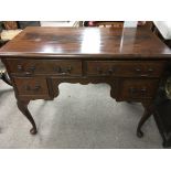 A mahogany dressing table fitted with four drawers