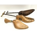 Three vintage wooden shoe stretchers.