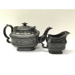 A black basalt Wedgwood style cream jug and confor