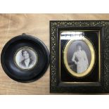 Two ebony photo frames, comprising a circular and rectangular example.