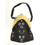 A predominantly black bead handbag with Indian mot