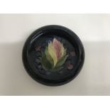 A moorcroft dish decorated with leaf and berry 10 cm