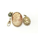 Three stone set pendants and a cameo brooch. Total