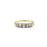 A ladies 18ct gold ring set with a band of five di