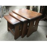 An Ercol nest of three Windsor tables.