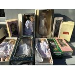 A collection of boxed porcelain dolls