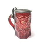 A bohemian red glass tankard etched with woodland